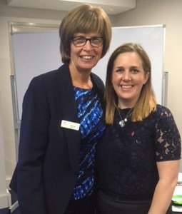 A picture of two women in business attire smiling
