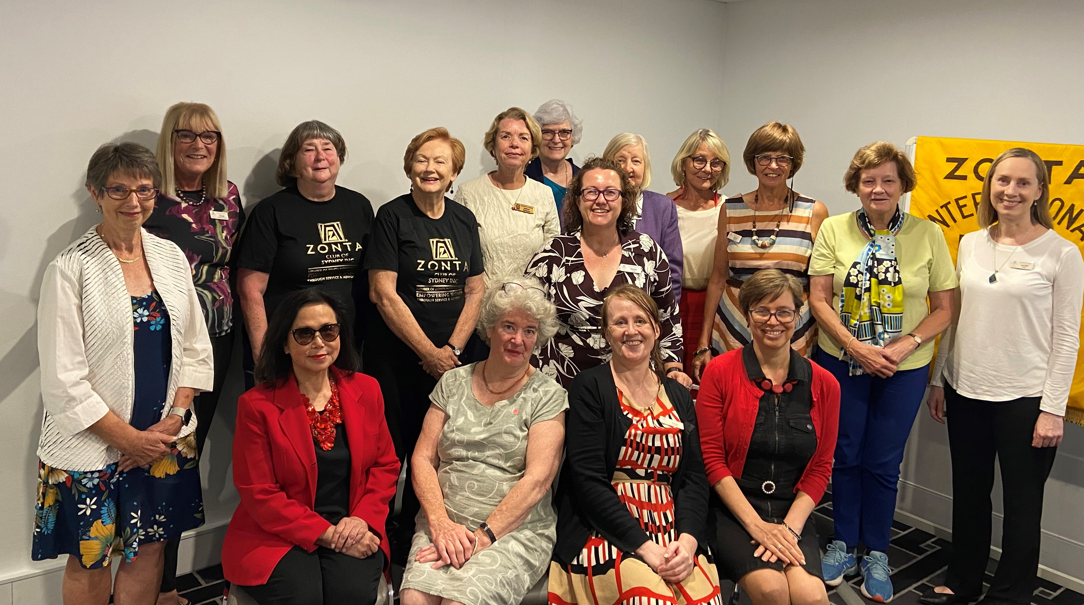 A group of women posing in front of a sign saying Zonta International